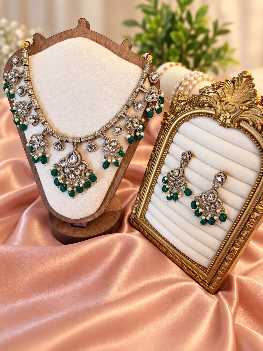 Mehrang necklace and earrings with green drops on cream jewellery displays